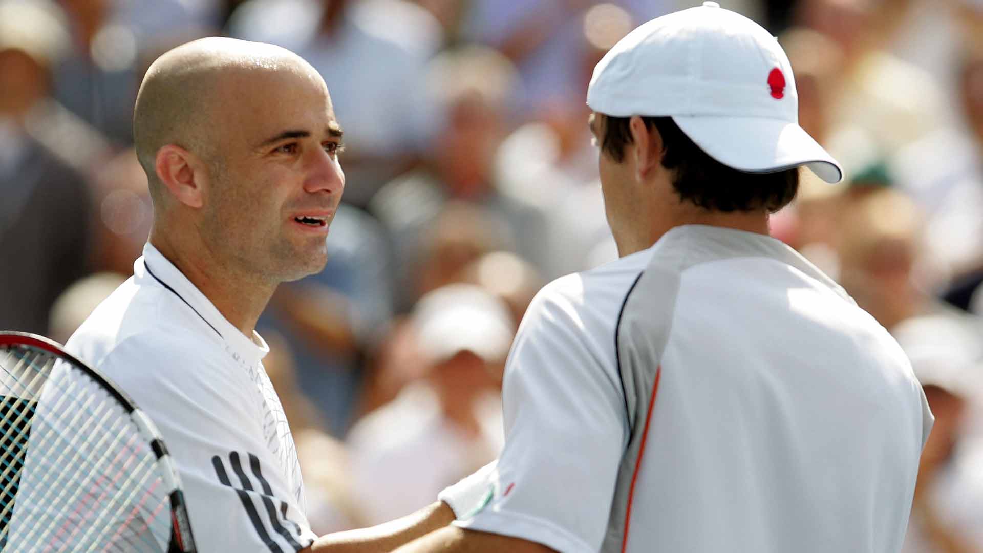 Andre Agassi shakes hands with Benjamin Becker after their match at the 2006 US Open.